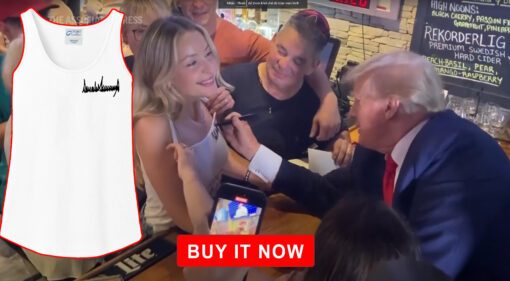 Trump autographs woman’s tank top shirt at Iowa campaign stop